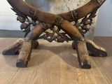 a wooden table with a large wooden animal on it ' s legs