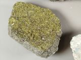 three rocks with moss growing on them on a white surface