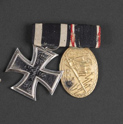 two medals and a medal on a black surface