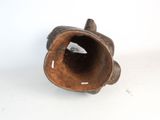 a brown vase with a hole in it sitting on a white surface