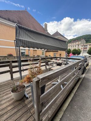 a wooden bench on the side of a building