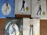 four pairs of tight stockings are sitting on a wooden table