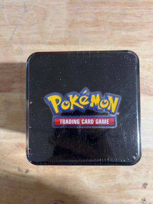 a black pokemon trading card game box sitting on top of a wooden table