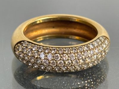an image of a gold and diamond ring on a table