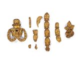 a lot of gold items that are on a white surface