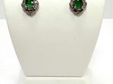 an image of a pair of earrings with green stones