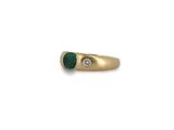 a gold ring with a green stone and a diamond