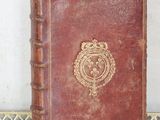 an old book sitting on top of a table next to a wall
