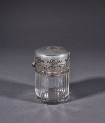 an antique silver plated glass jar with a silver lid