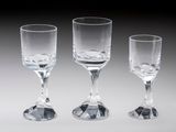 three empty wine glasses sitting next to each other on a table