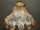 an image of a glass light fixture hanging from a ceiling