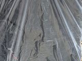 a black umbrella that is wrapped up on a pallet