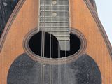 a close up of a guitar with a hole in the neck
