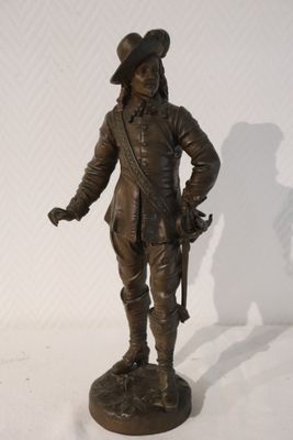 statue of a man with a hat and a gun on a white surface