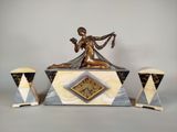 a statue of a woman sitting on top of a clock