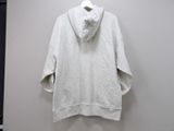 white hoodie on a hanger in front of a white wall