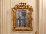 a mirror on the wall above a sink in a bathroom