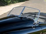 a close up of a black sports car parked on the side of the road