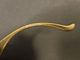 a close up of a pair of sunglasses with a gold frame