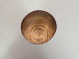 a metal cup that is sitting on a table