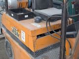 a small orange forklift with a black seat on it