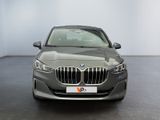 the front view of a grey bmw 6 series sedan parked in a showroom