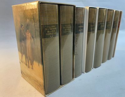 six books in a row on a table with a white background