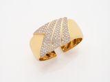 a close up of a gold and diamond ring on a white surface