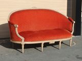 a red couch that is sitting in front of a wall