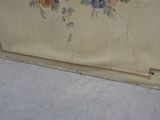 a painting on the wall of a room with a cat sitting on the floor