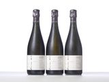 three bottles of wine sitting on top of a table next to each other