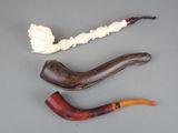 three different types of smoking pipes on the table