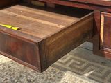 a wooden desk with a drawer underneath it