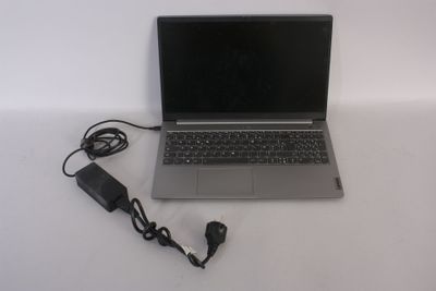 a laptop that is sitting on a table with a charger