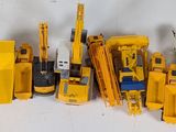 a lot of toy construction vehicles that are lined up together