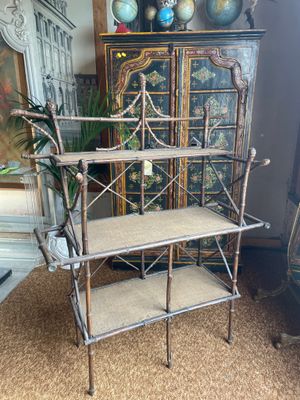 an antique metal shelf with two shelves on top of it