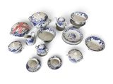 many pieces of blue and white porcelain on a white surface