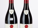 deux bouteilles de vin rouge posées l'une à côté de l'autre sur une table
