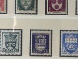 several different colored stamps are displayed on a wall in a room