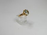 an image of a gold ring with a blue topaz stone