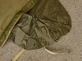 a sleeping bag on the floor next to a pillow
