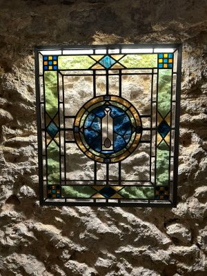 un vitrail dans un coin d'un mur de pierre