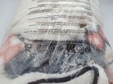 a bag of wool and a pair of scissors on a table
