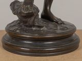 a bronze statue of a dog and a cat on a table