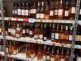 bottles of wine are on a shelf in a liquor store