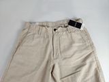 the shorts are tan and have a black tag on it