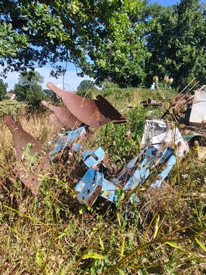 a motorcycle that is sitting in the grass near a tree
