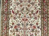 a white rug with a tree of life design on it