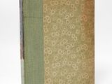 a book with a green cover sitting on top of a white surface