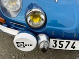 a close up of a blue car with a number plate on it